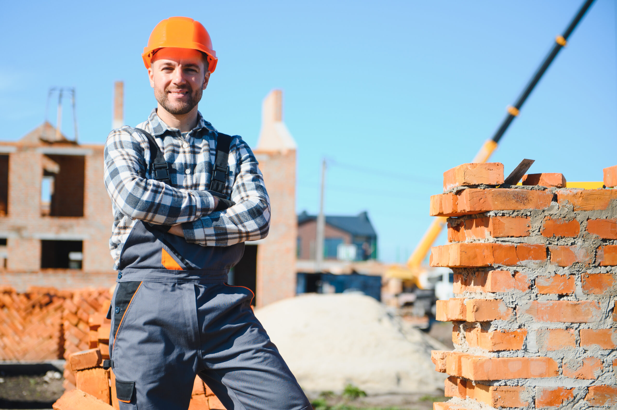 Construction worker in uniform and safety equipment have job on building.